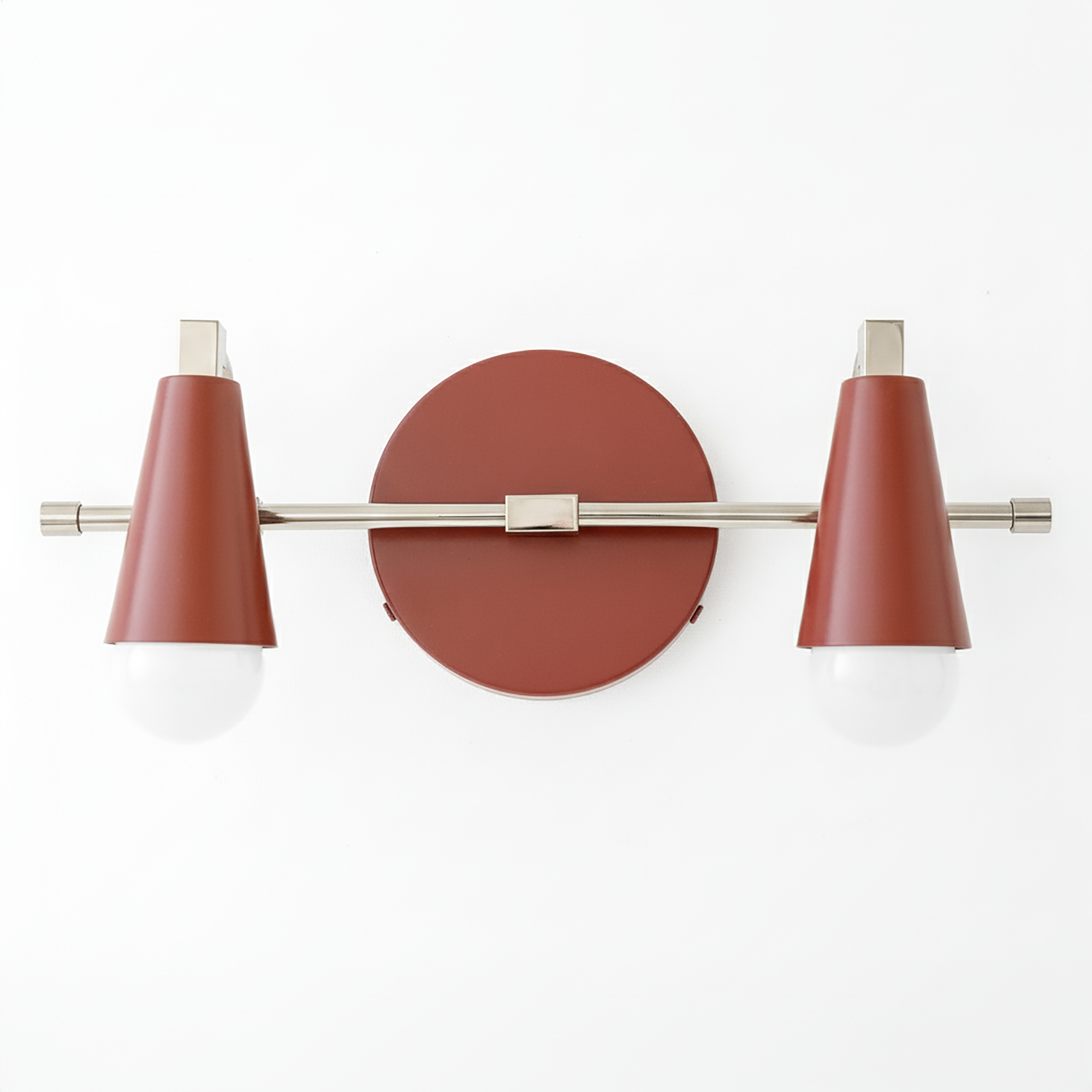 Industrial-style vanity light with two bare bulbs, rust-colored conical shades, and brushed metal accents. - VANITY LIGHT MODEL NO. 1229
