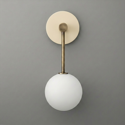 Wall-mounted sconce with aged brass finish and a single frosted white globe light shade. - Sconce Model No. 5999