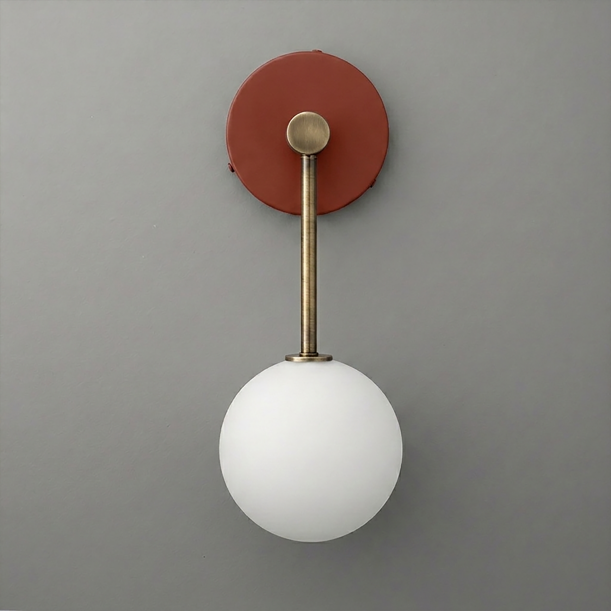 Wall sconce with brushed brass fixture and frosted white glass globe shade. - Sconce Model No. 5999