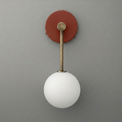 Wall sconce with brushed brass fixture and frosted white glass globe shade. - Sconce Model No. 5999