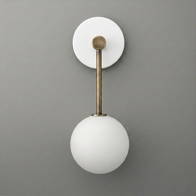Wall sconce with matte white glass globe shade and brass-finished metal arm on round white backplate. - Sconce Model No. 5999