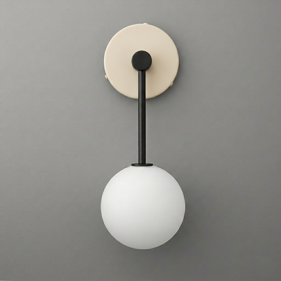 Wall sconce with matte black metal rod and frosted white glass globe shade on beige circular mount. - Sconce Model No. 5999