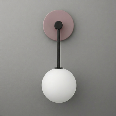 Wall sconce with a matte black arm, muted lavender round backplate, and frosted white glass globe shade. - Sconce Model No. 5999