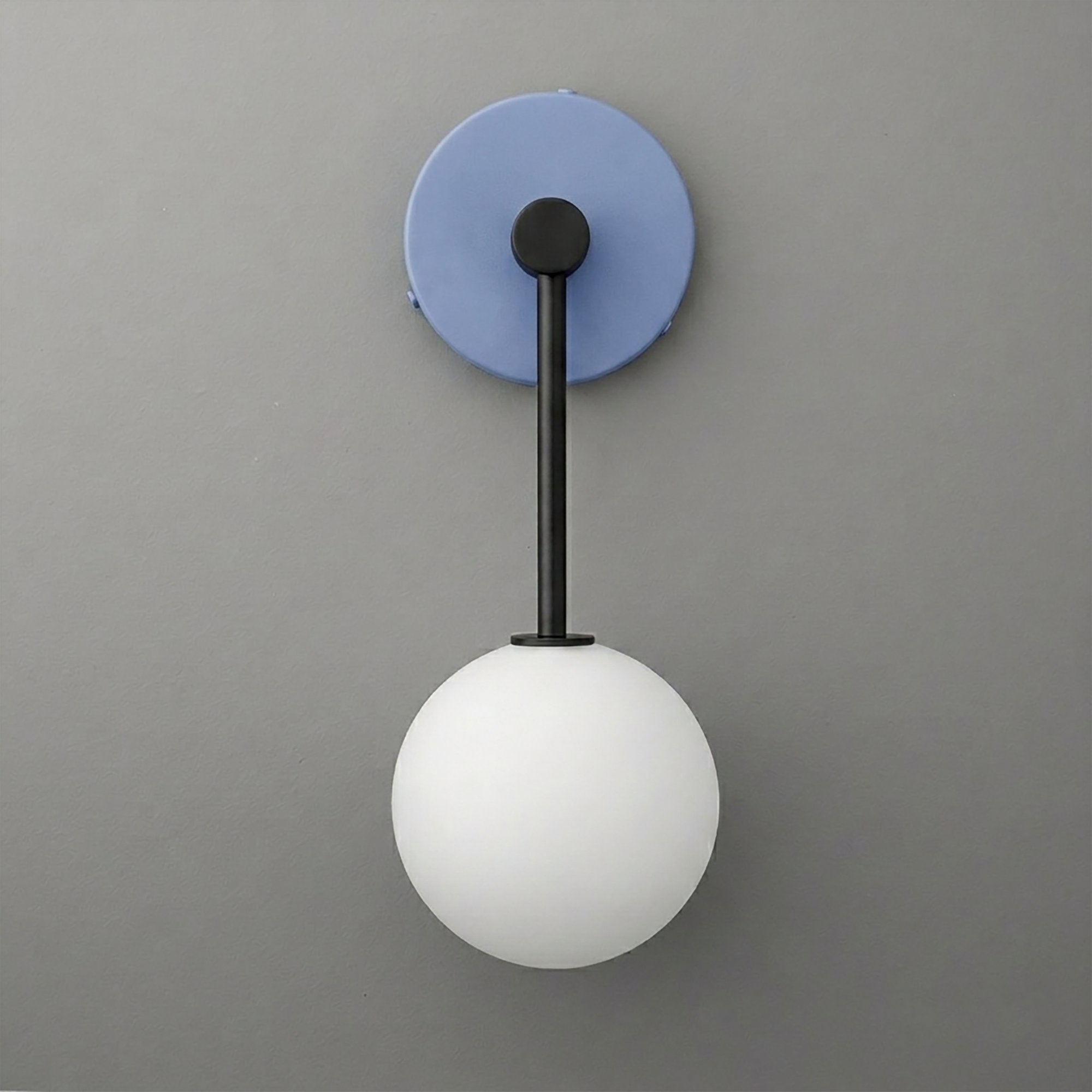 Black metal wall sconce with a round blue backplate and a white frosted glass globe shade. - Sconce Model No. 5999
