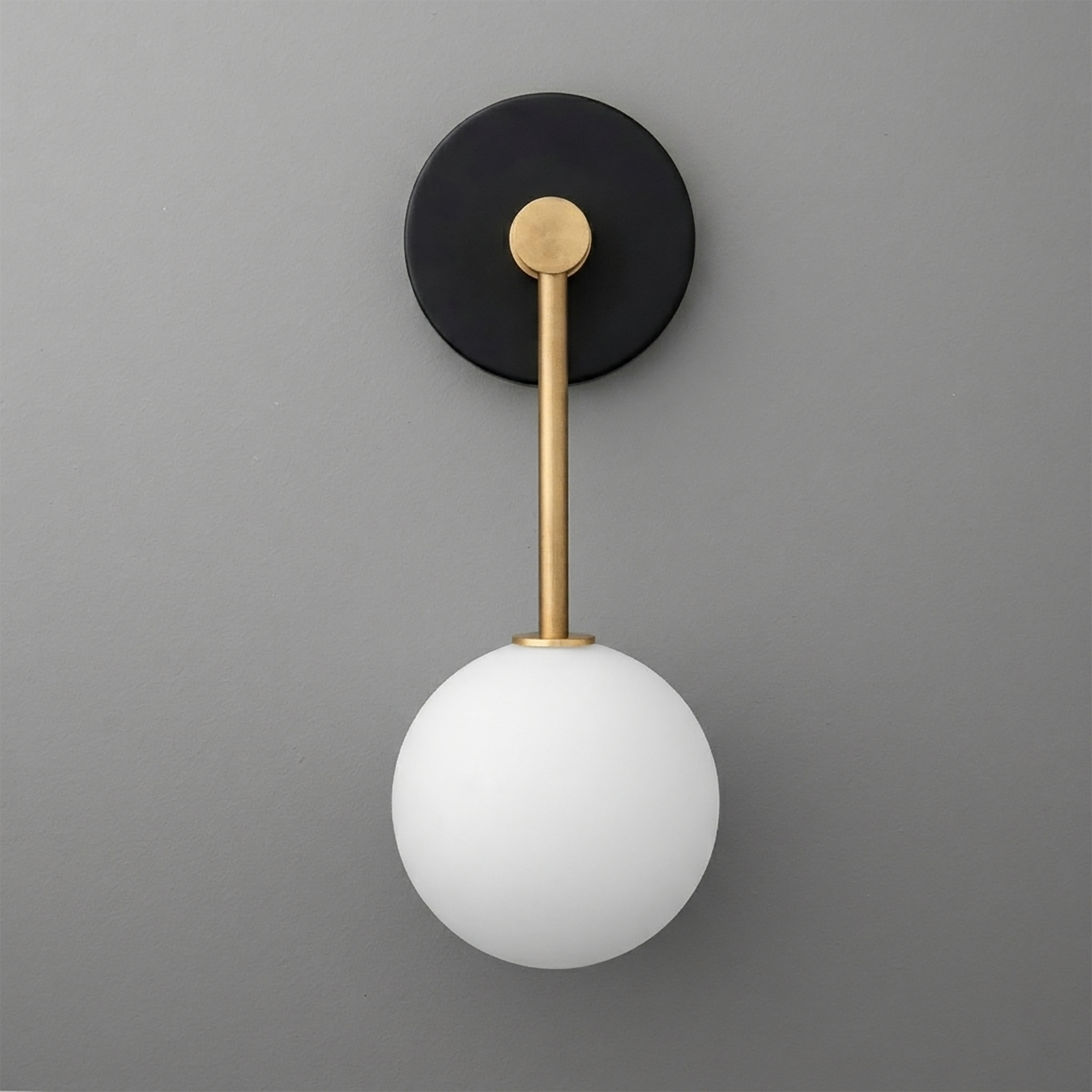 Wall sconce with matte black round base, brass rod, and frosted white glass globe shade. - Sconce Model No. 5999