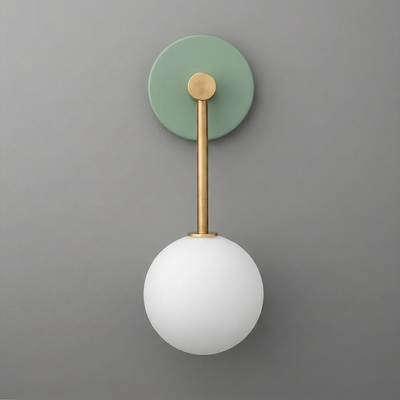 Minimalist wall sconce with matte green circular backplate, brass rod, and white frosted glass globe shade. - Sconce Model No. 5999