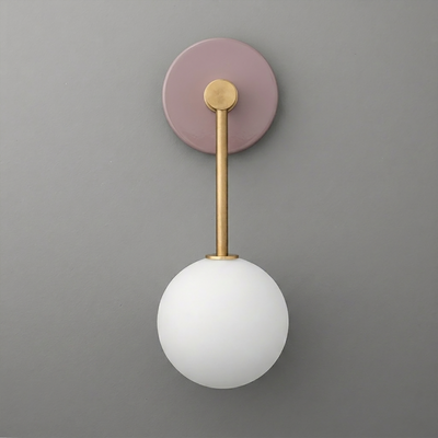 Wall sconce with a round matte mauve base, brass rod, and frosted white glass globe shade. - Sconce Model No. 5999