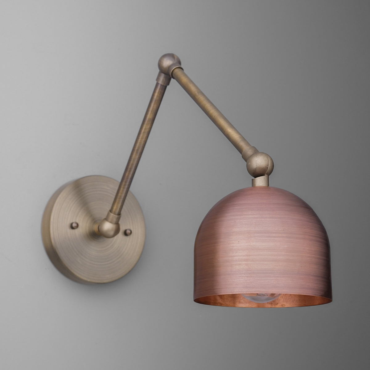 Adjustable arm wall sconce with brushed bronze finish and copper-toned dome shade. - SCONCE MODEL NO. 5997