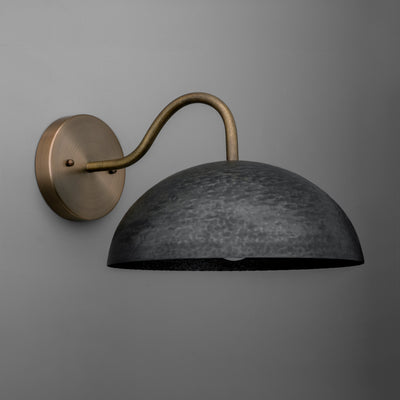 Wall-mounted sconce with a weathered black dome shade and an antique brass curved arm and round base. - SCONCE MODEL NO. 9874