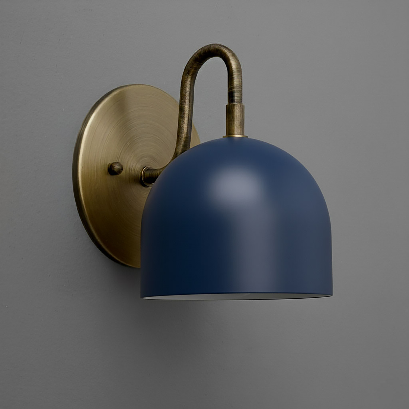 Wall sconce with matte blue dome shade and antique brass curved arm and round backplate. - Sconce Model No. 5416