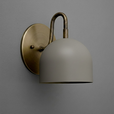 Wall sconce with brushed brass oval base and curved arm, matte gray dome-shaped shade. - Sconce Model No. 5416