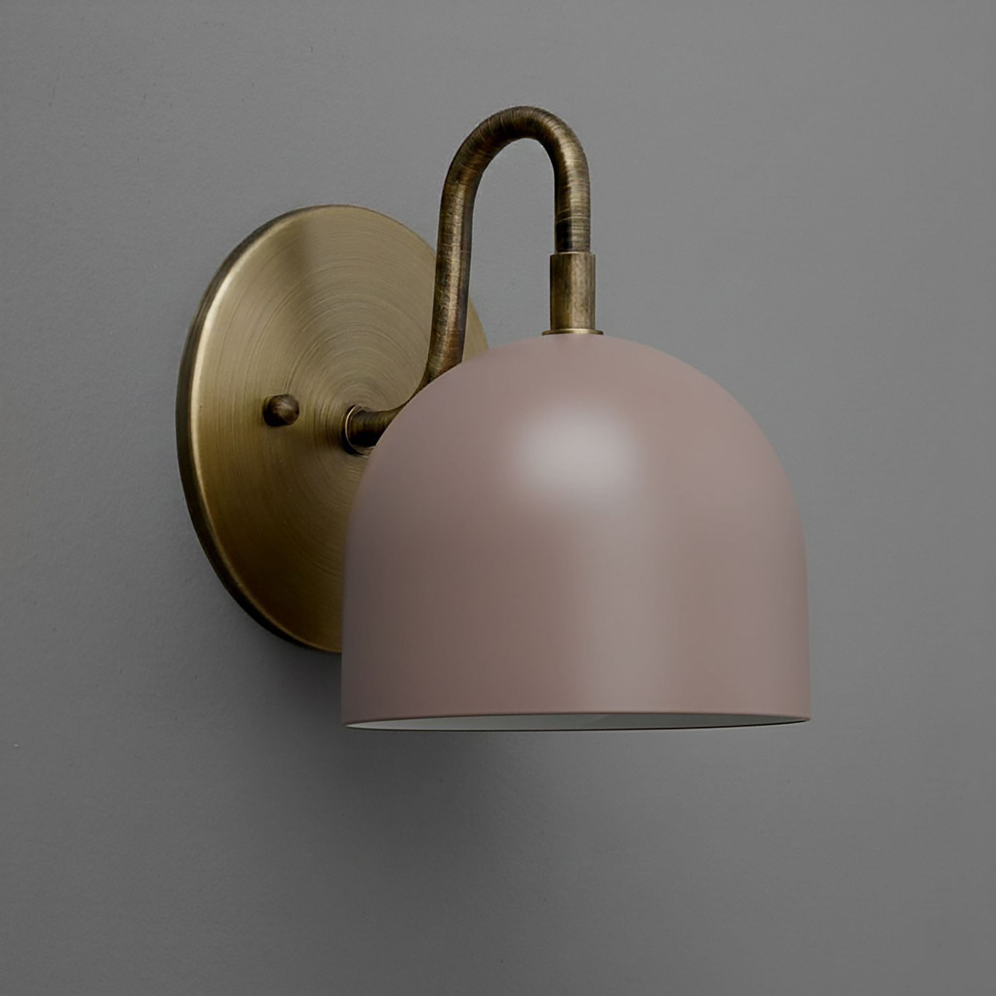 Wall-mounted sconce with matte brass base and curved arm, featuring a matte mauve dome-shaped shade. - Sconce Model No. 5416
