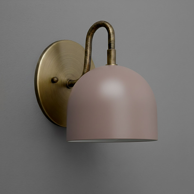 Wall-mounted sconce with matte brass base and curved arm, featuring a matte mauve dome-shaped shade. - Sconce Model No. 5416