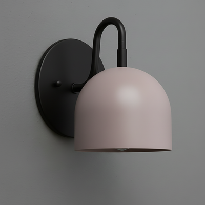Matte black wall sconce with a smooth, dome-shaped pale pink shade and curved arm mount. - Sconce Model No. 5416