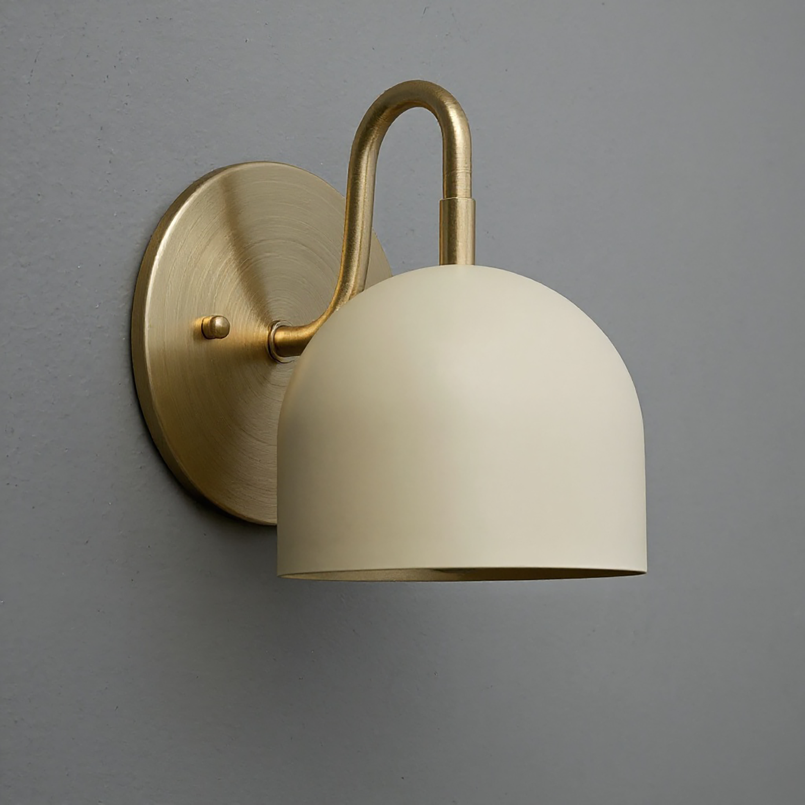Matte gold metal wall sconce with smooth cream dome shade and curved arm, modern design. - Sconce Model No. 5416