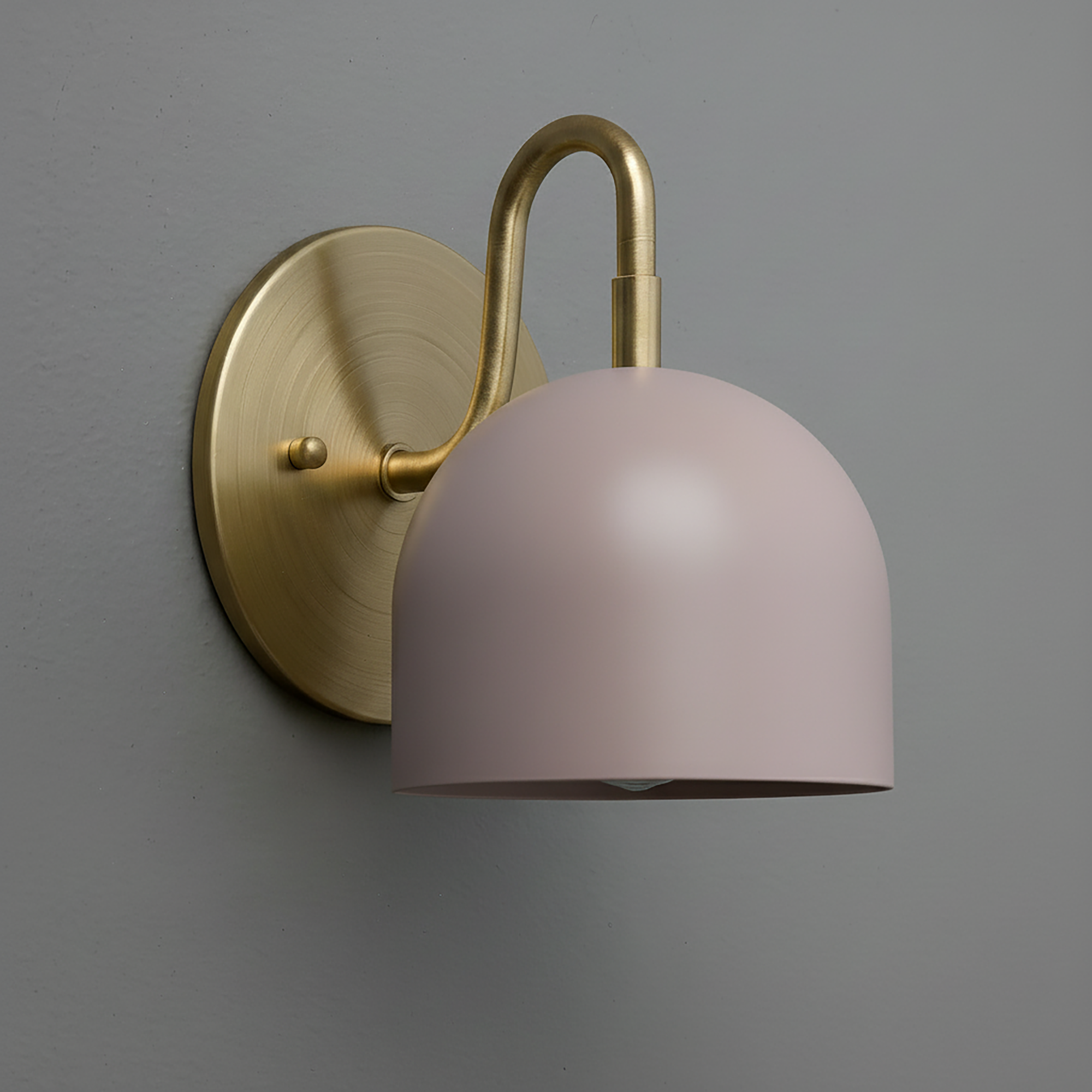 Matte pink dome-shaped metal shade sconce with brushed brass curved arm and round wall mount. - Sconce Model No. 5416