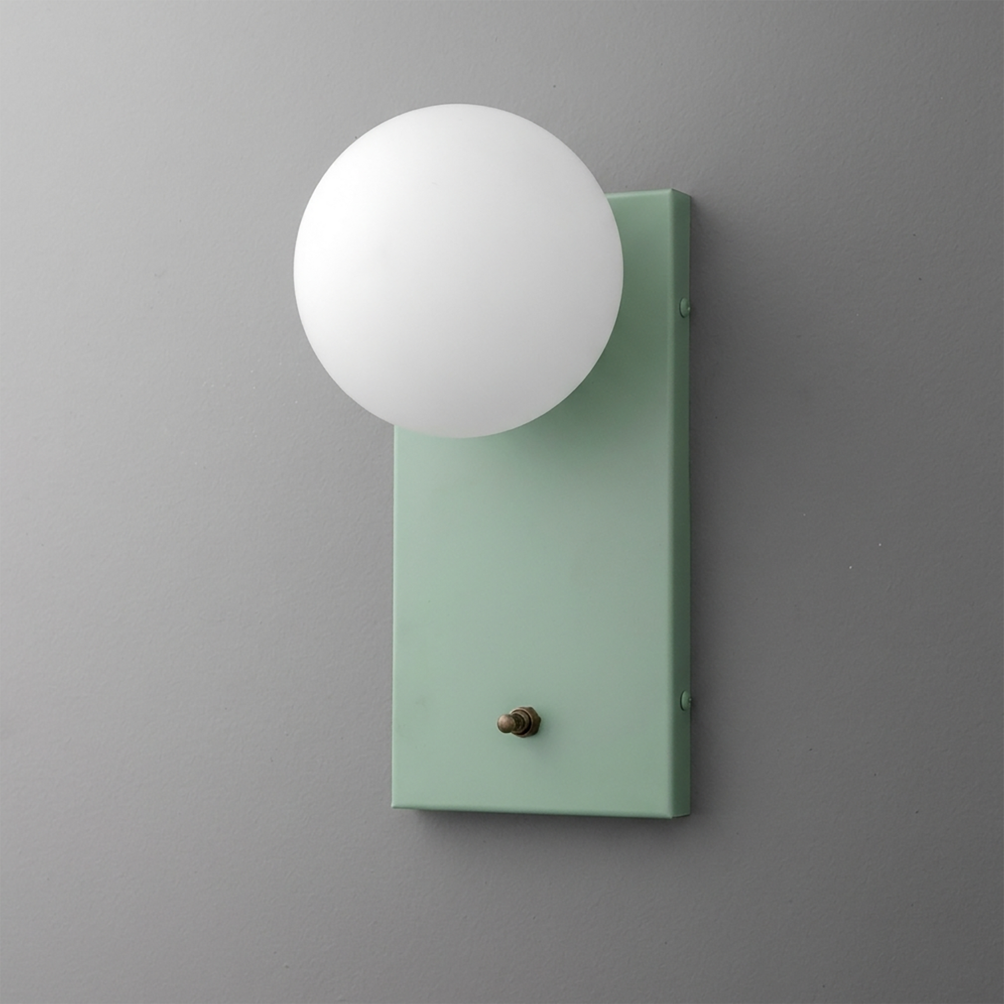 Minimalist wall sconce with frosted white globe shade and matte sage green rectangular base. - Sconce Model No. 2196