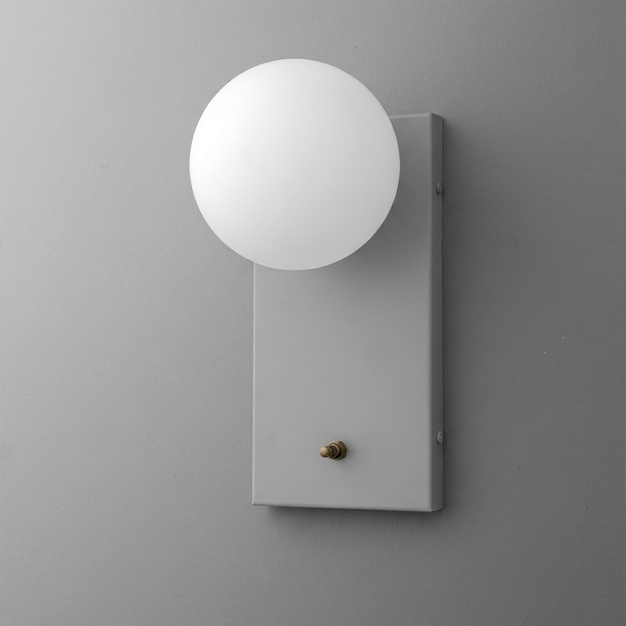 Matte gray rectangular wall sconce with a round white frosted glass globe shade and a small brass switch knob. - Sconce Model No. 2196
