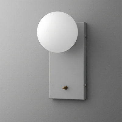 Matte gray rectangular wall sconce with a round white frosted glass globe shade and a small brass switch knob. - Sconce Model No. 2196