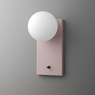 Matte pink rectangular metal sconce with a white frosted globe bulb and small brass switch at base. - Sconce Model No. 2196