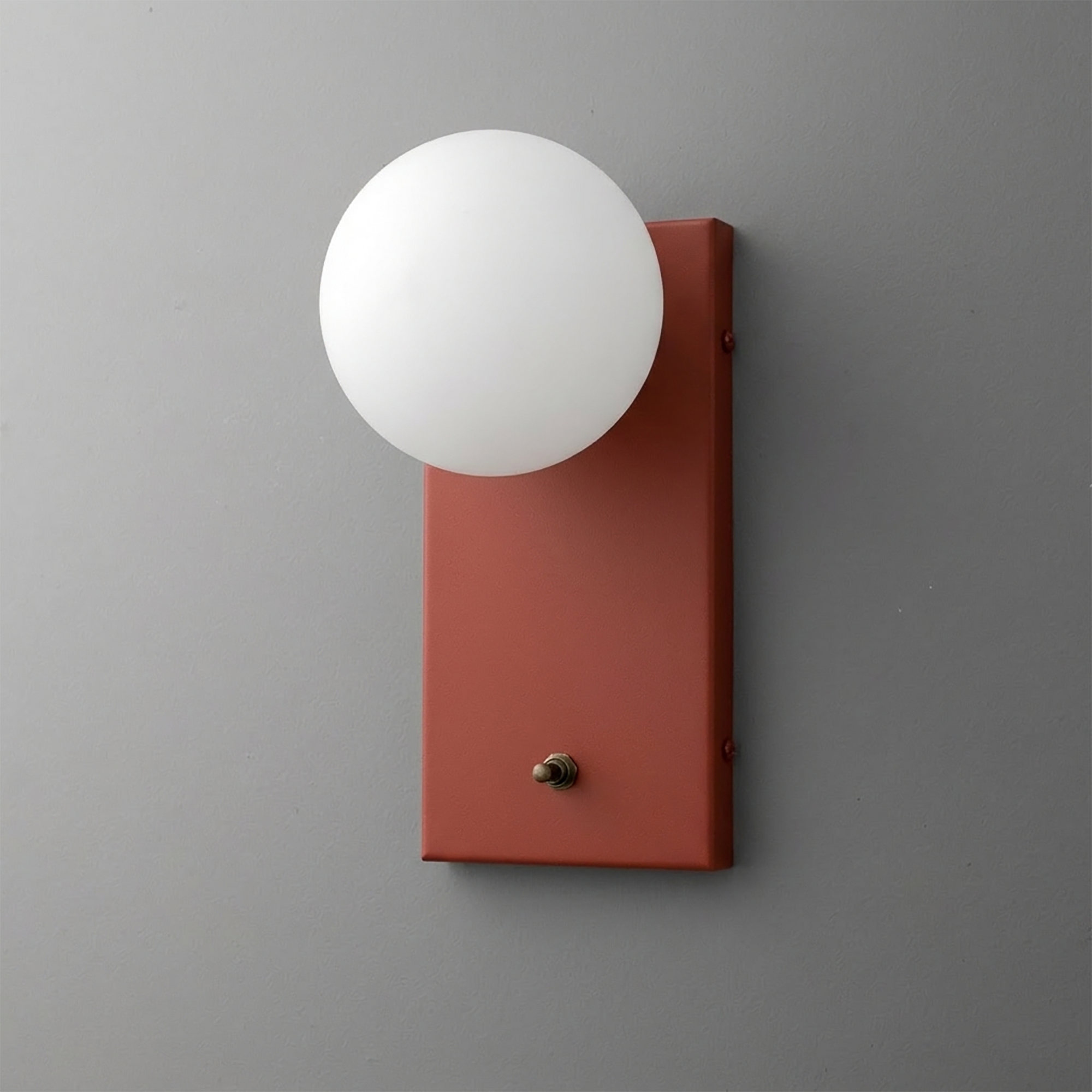 Wall sconce with matte rust-red rectangular metal backplate and frosted white glass globe shade. - Sconce Model No. 2196