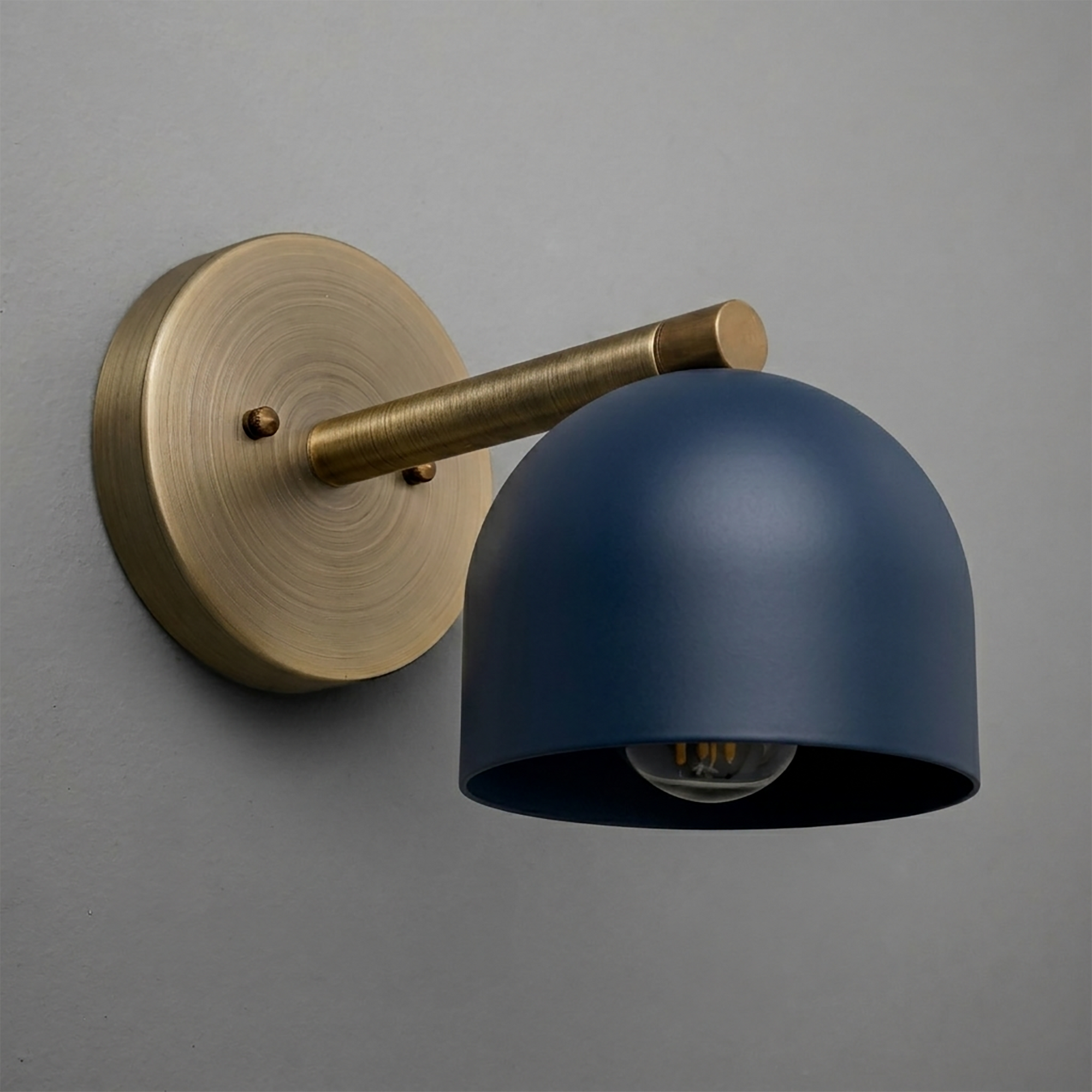 Wall sconce with matte navy blue deep dome shade and brushed brass circular mount and arm. - Sconce Model No. 5356