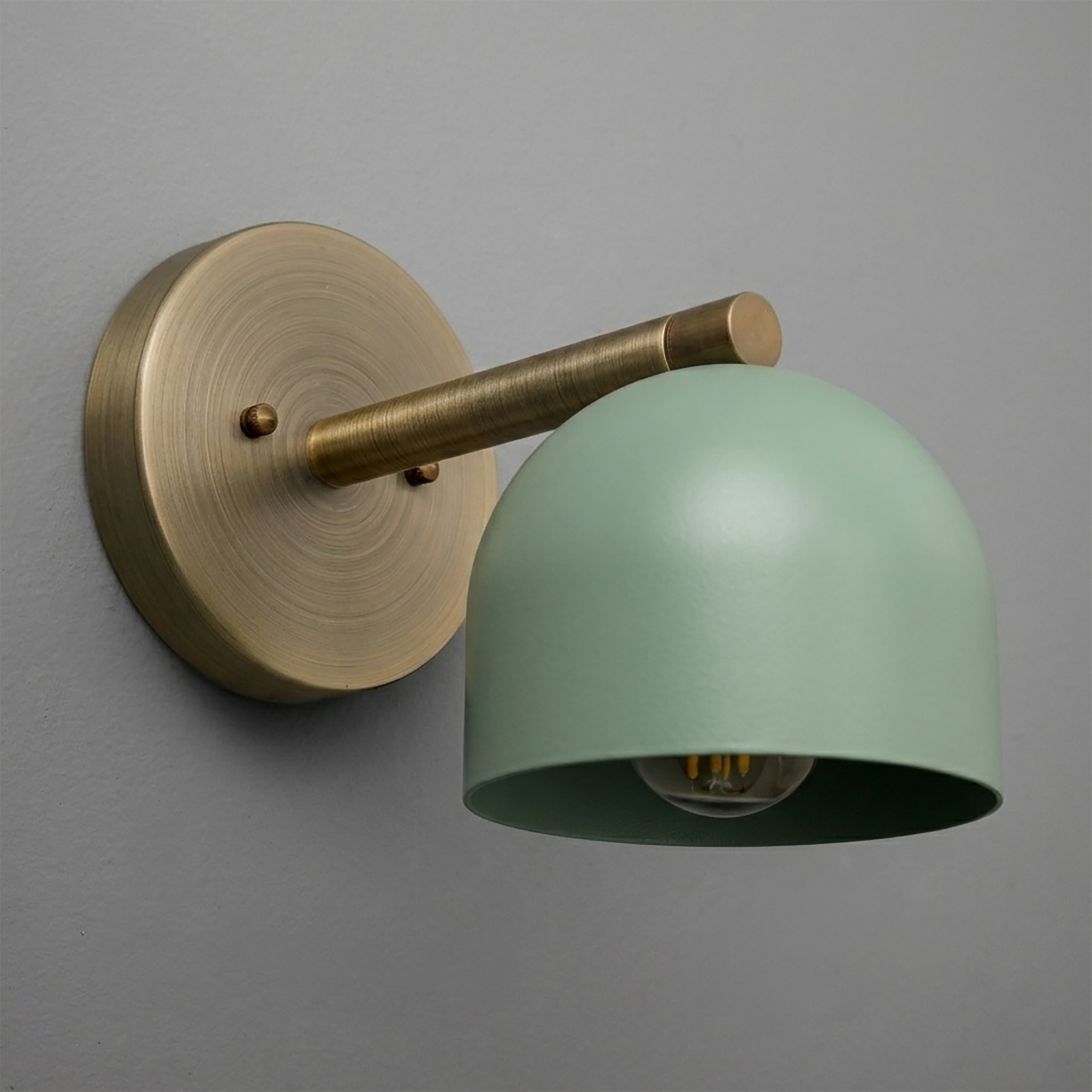 Wall-mounted sconce with matte brass arm and round base, featuring a smooth seafoam green dome shade. - Sconce Model No. 5356