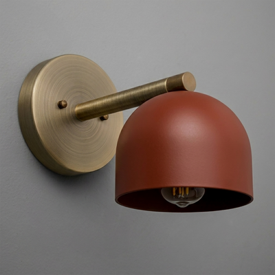 Wall sconce with matte rust red dome shade and brushed brass circular base and arm. - Sconce Model No. 5356