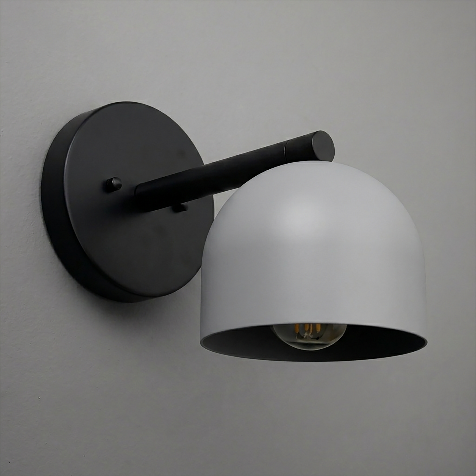 Black metal wall sconce with dome-shaped frosted white glass shade and single exposed bulb. - Sconce Model No. 5356