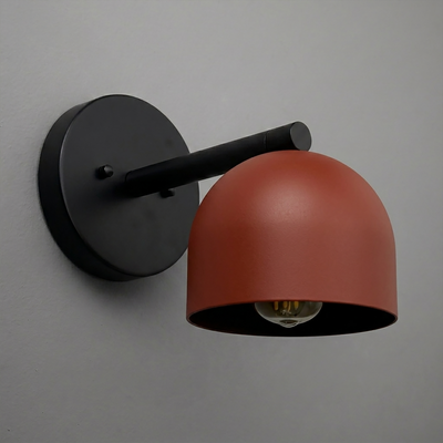 Matte black metal wall sconce with a rust-red dome-shaped shade and exposed bulb, modern design. - Sconce Model No. 5356