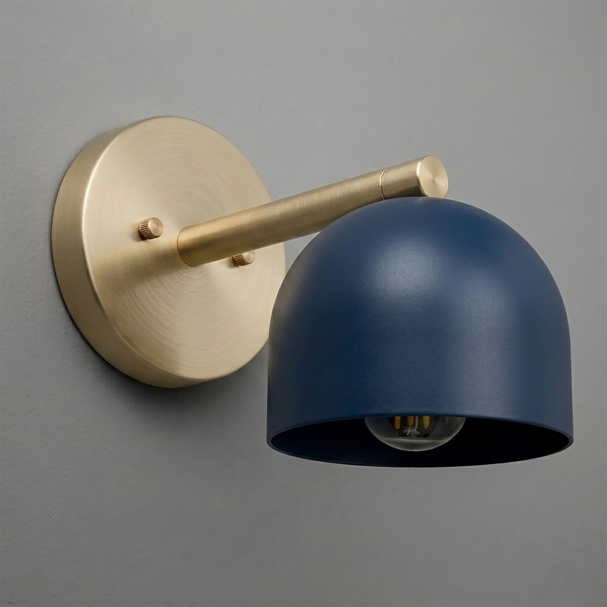 Brushed brass wall sconce with matte navy blue dome-shaped metal shade and exposed bulb design. - Sconce Model No. 5356