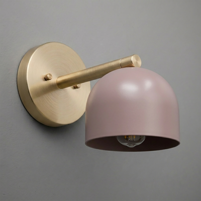 Matte brass wall sconce with cylindrical arm and mauve dome-shaped metal shade. - Sconce Model No. 5356