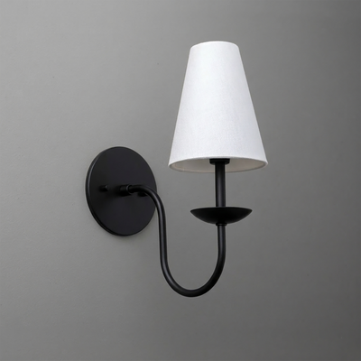Black metal single-arm wall sconce with white tapered fabric shade and round backplate. - SCONCE MODEL NO. 7085