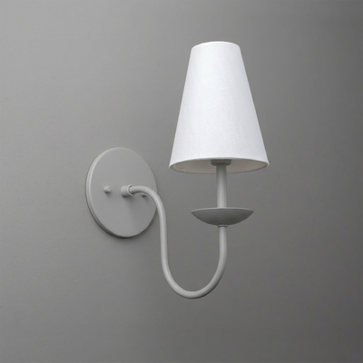 White metal wall sconce with round base and curved arm holding a fabric tapered lampshade. - SCONCE MODEL NO. 7085
