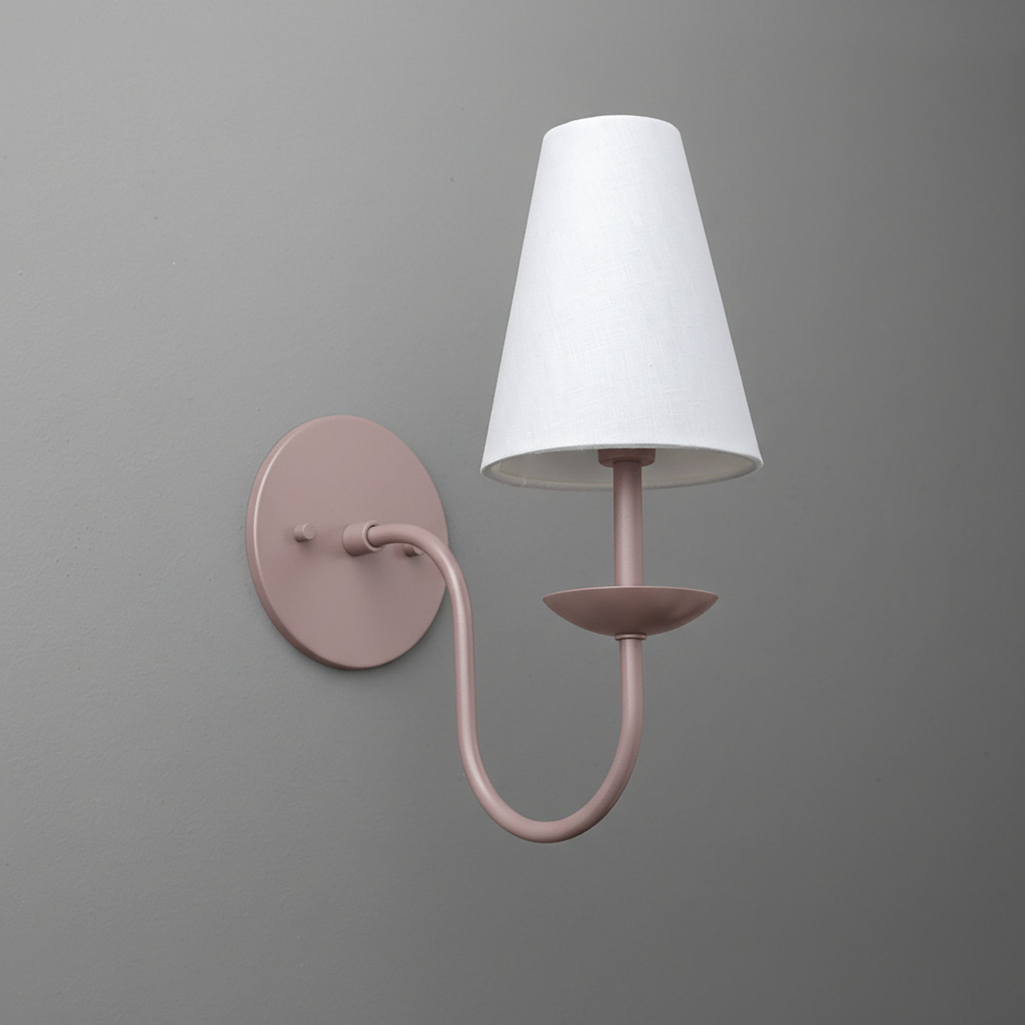 Matte pink metal wall sconce with curved arm and white tapered fabric shade. - SCONCE MODEL NO. 7085