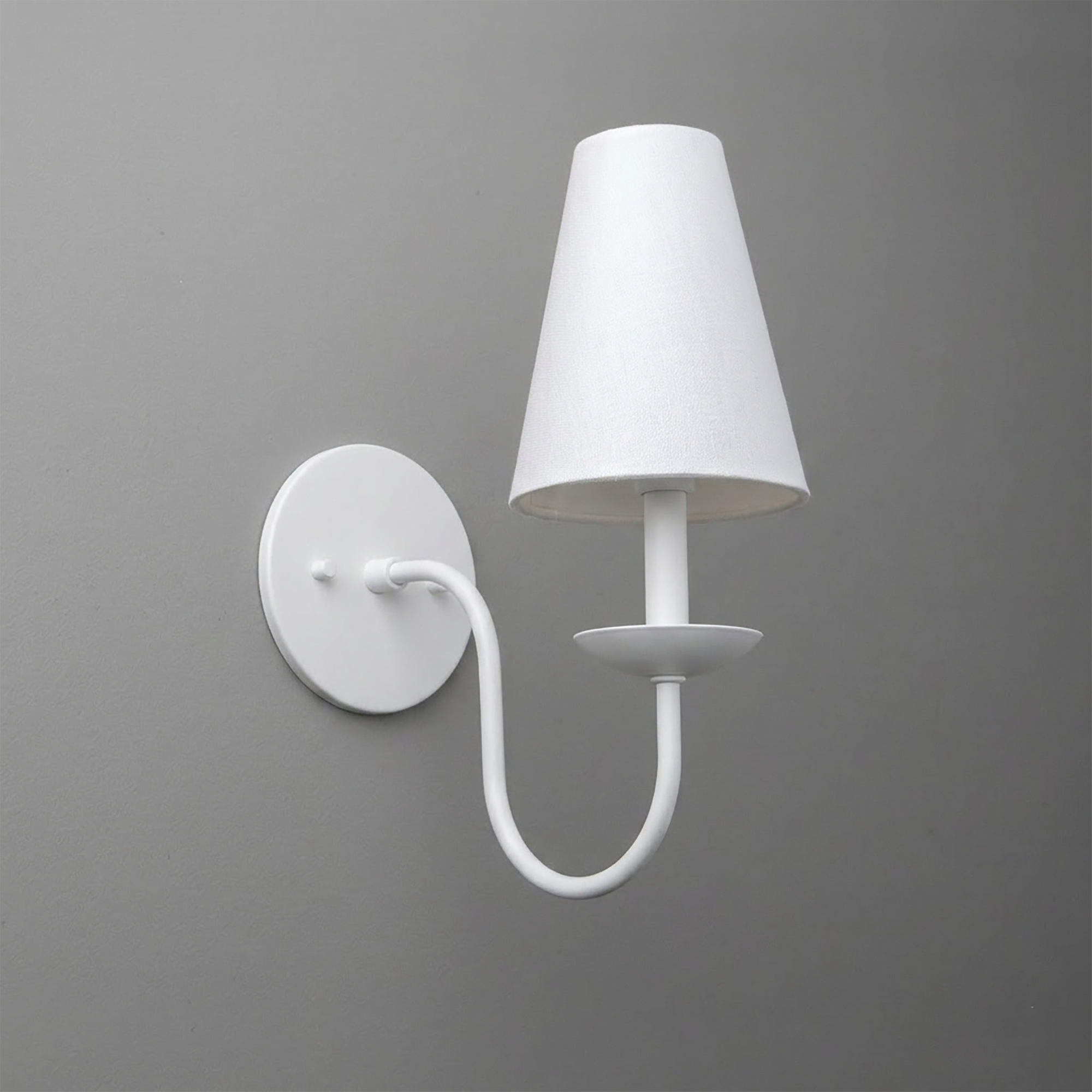 White metal wall sconce with curved arm and tapered fabric lampshade. - SCONCE MODEL NO. 7085