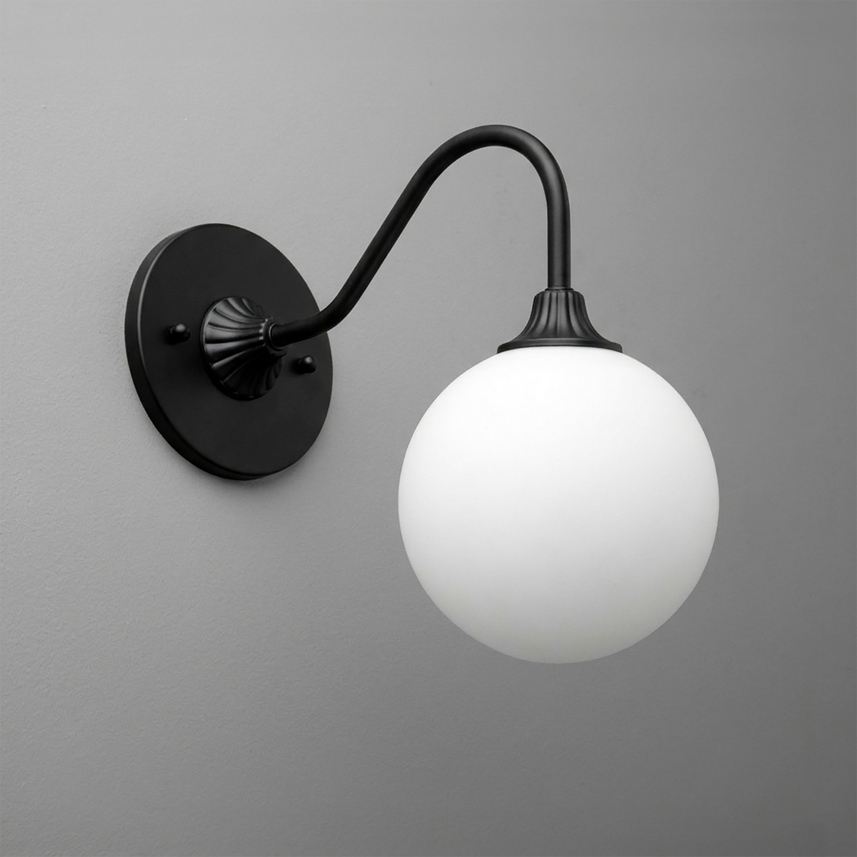 Black metal wall sconce with curved arm and frosted white glass globe shade. - SCONCE MODEL NO. 8263