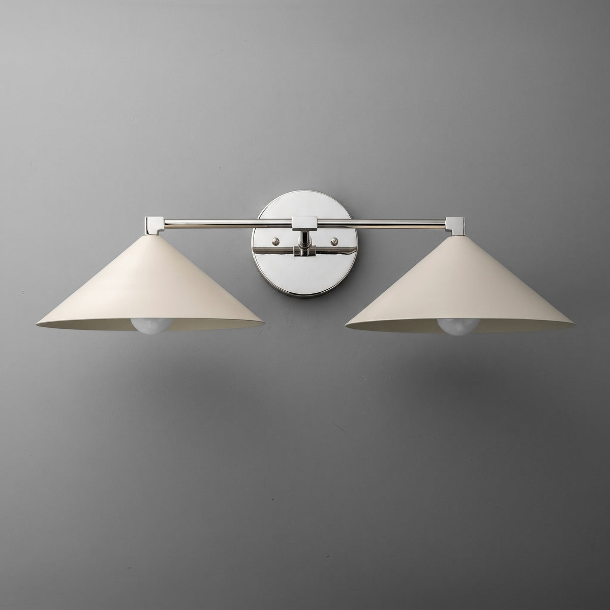 Two-light vanity light in Polished Nickel with wide steel cone shades on a straight arm and a round wall plate. - VANITY LIGHT MODEL NO. 1185