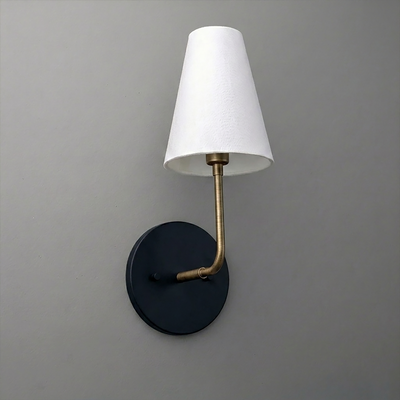 Wall sconce with black circular base, brass arm, and white tapered fabric lampshade. - SCONCE MODEL NO. 3928
