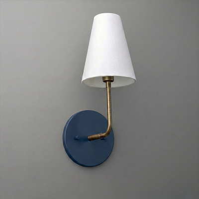 Wall-mounted sconce with blue circular base, brass arm, and white tapered fabric shade. - SCONCE MODEL NO. 3928