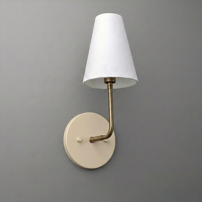 Single-bulb wall sconce with round cream base, slender brass arm, and white tapered fabric shade. - SCONCE MODEL NO. 3928