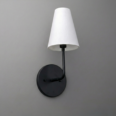 Black metal sconce with a round base and white tapered fabric shade. - SCONCE MODEL NO. 3928