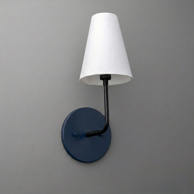 Wall sconce with a matte black metal arm and round base, topped with a white tapered fabric lampshade. - SCONCE MODEL NO. 3928