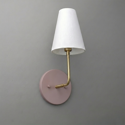 Wall sconce with round matte pink base, brass arm, and white tapered fabric shade. - SCONCE MODEL NO. 3928