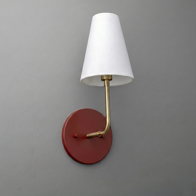 Wall sconce with round rust-colored metal base, brass arm, and white tapered fabric shade. - SCONCE MODEL NO. 3928