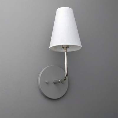 Metal wall sconce with round base and curved arm holding a white fabric tapered lampshade. - SCONCE MODEL NO. 3928