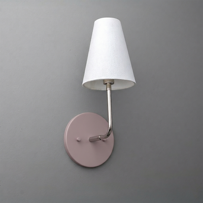 Wall-mounted single-bulb sconce with a round pink metal base and white tapered fabric shade. - SCONCE MODEL NO. 3928