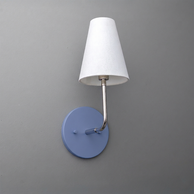 Wall-mounted sconce with blue circular metal base, brushed metal arm, and white tapered fabric shade. - SCONCE MODEL NO. 3928