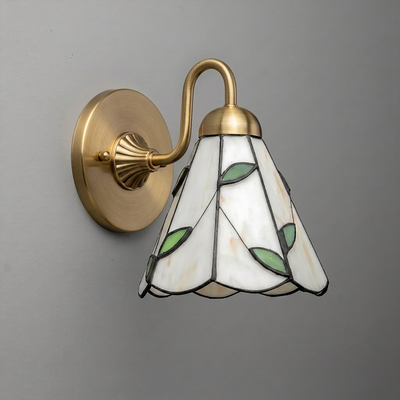 Wall-mounted brass sconce with a stained glass lampshade featuring white panels and green leaf accents. - SCONCE MODEL NO. 8543