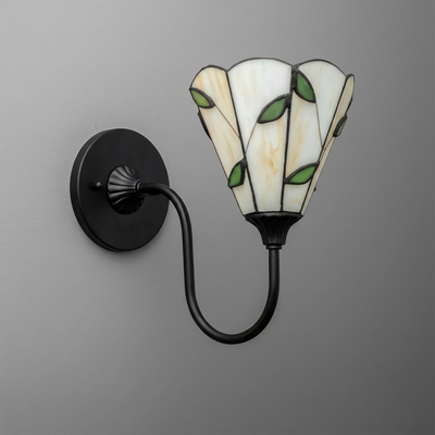Wall sconce with black metal curved arm and stained glass shade featuring white panels and green leaf accents. - SCONCE MODEL NO. 1053